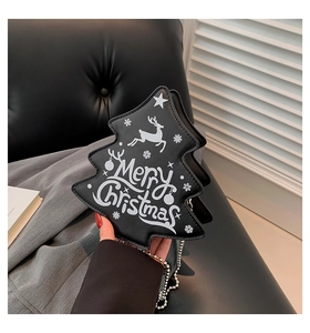 Detail of Christmas tree shaped black leather bag with silver chain and festive print