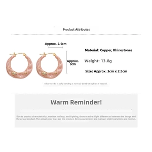 Macro detail of pink marble enamel hoop earrings with rhinestone accents and copper base