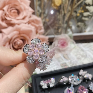 Detailed macro view of the 18K silver and pink rhinestone double flower ring