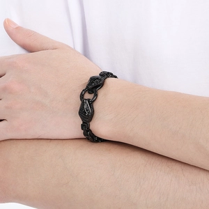 Detailed close-up of a men's black stainless steel snake head bracelet worn on a wrist