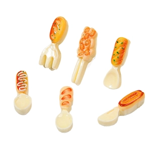 Miniature resin cutlery set with food-shaped handles on a white background