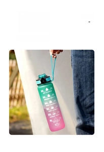 Detail of 32oz gradient sports water bottle with nylon carry strap and time markers