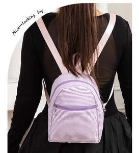 Detail of purple and white striped seersucker mini backpack with pink nylon straps