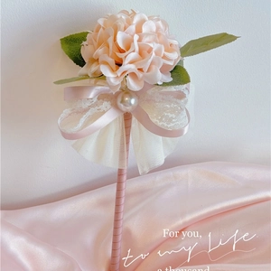 Pink hydrangea floral ball pen with white lace bow and pearl on silk background