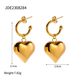 Detailed view of gold heart drop earrings in stainless steel with polished finish