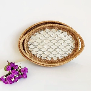 Detail of two-piece rattan tray set with white shell inlay and side handles