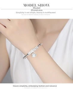 Detail of silver-plated bell bracelet showing intricate hollow beadwork on the wrist