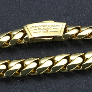 Detailed macro view of 14K gold Cuban chain with Monaco Chain clasp engraving