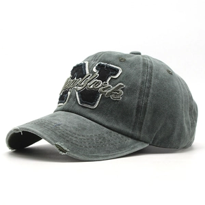 Detailed macro of vintage washed cotton baseball cap with New York embroidery and distressed brim