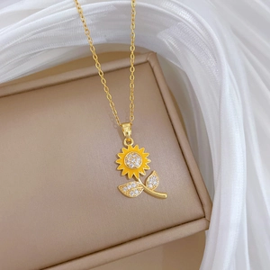 Detail of golden sunflower necklace with sparkling cubic zirconia on a beige gift box