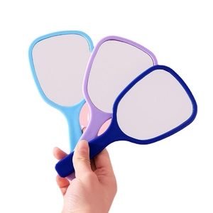 Three handheld makeup mirrors in navy, purple, and light blue with sleek plastic frames