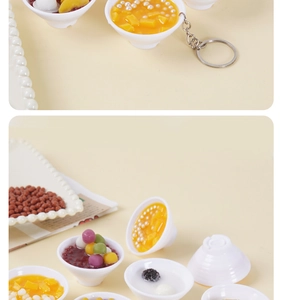 Macro detail of artificial dessert bowl keychain with realistic mango pudding and red bean