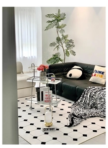 Detail of modern black and white hexagonal rug with zebra pattern throw for living room