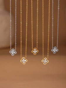 Detail of luxury clover pendants in gold and silver finishes with shimmering crystals
