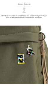 Detailed macro of enamel space badges with star and window designs on a canvas bag
