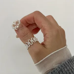 Macro view of woven hollow silver ring with vintage multi-layer crisscross design