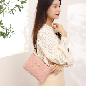 Elegant pink quilted PU leather crossbody bag with gold chain strap and metal plate detail