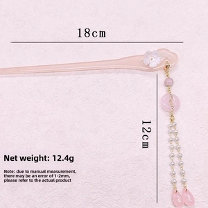 Detail of pink floral hair stick showing 18cm length and 12cm tassel measurements