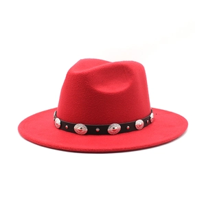Detail of red fedora hat featuring a black leather band with vintage silver metal studs