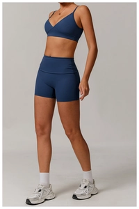 Detail of dark blue high-elastic yoga set with V-neck sports bra and seamless shorts