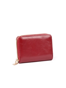 Detail of red leather accordion card holder with golden metal zipper and smooth texture