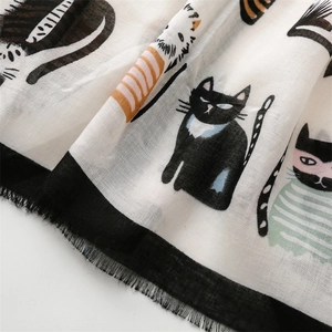 Macro shot of cotton-satin scarf featuring cute cat prints and fine fringed edges