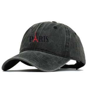 Detailed view of Paris Eiffel Tower embroidery on washed grey denim baseball cap