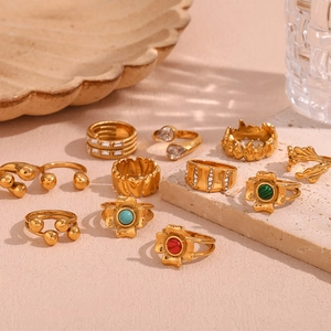 Detail of 18K gold plated stainless steel rings with zircon and colorful gemstones