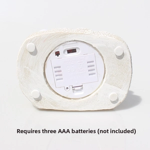 Detail of the white resin base featuring a battery compartment and toggle power switch
