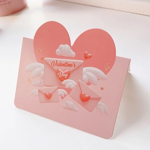 Detail view of pink Valentine's Day card with 3D heart-shaped wings and envelope