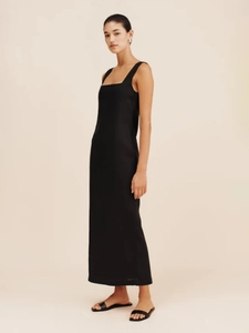 Detail of minimalist black square neck sleeveless maxi dress with smooth linen texture