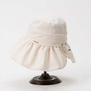 Detail view of wide brim sun hat with Senmao metal logo and adjustable drawstring