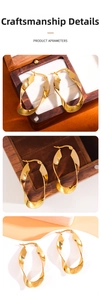 Close-up detail of 18K gold-plated stainless steel twisted hoop earrings with mirror finish