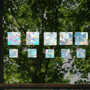 Close-up of rainbow prism static glass film samples with laser broken glass texture