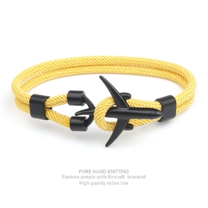 Detail of hand-knitted yellow Milan rope bracelet featuring a matte black airplane clasp