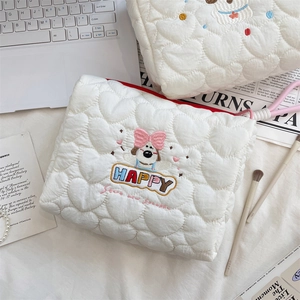 Detail of cream white quilted heart makeup bag set with cute puppy embroidery and pink handle