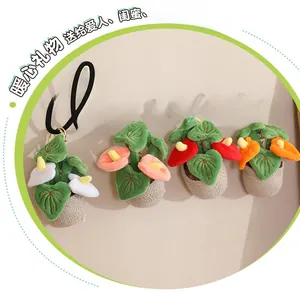 Detailed view of four colorful plush flower keychain pendants with golden metal hooks