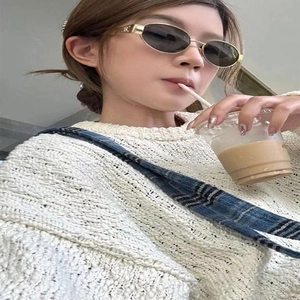 Vintage oval metal frame sunglasses with gold logo and dark grey lenses for fashion use