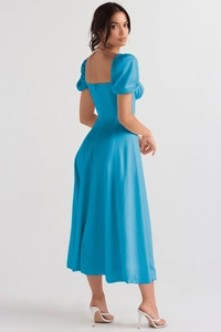 Close-up of the square neck open back design and invisible zipper on the blue satin dress