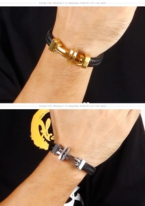 Detail of woven leather bracelet with dual-tone cross metal clasps worn on wrist