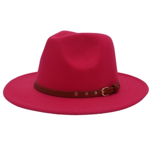 Fashionable rose red wool jazz hat with brown leather belt and gold buckle on white background