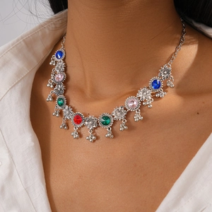 Close-up of vintage flower necklace with colorful rhinestones and metal bead tassels