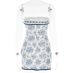 Back view of blue toile floral mini dress with ruffles and lace-up ribbon detail