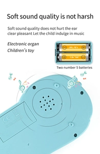 Detail view of the soft sound speaker and AA battery compartment on blue kids toy organ