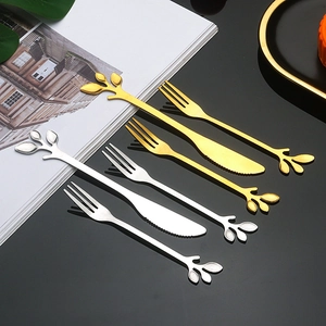 Golden and silver stainless steel leaf cutlery set with forks and knives on black background