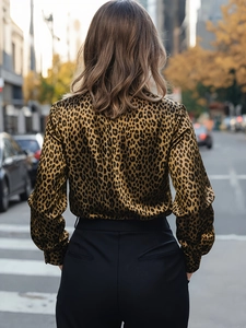 Detail of the leopard print satin shirt back view featuring a glossy fabric texture