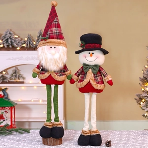 Detailed view of handmade Christmas plush dolls featuring plaid fabric and soft fur textures