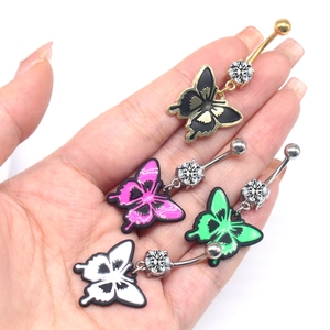 Macro view of butterfly navel rings with vibrant enamel wings and sparkling zircon stone