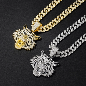 Gold and silver iced out cuban link necklaces with diamond encrusted tiger head pendants