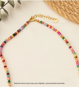 Detail of colorful natural stone beaded necklace with golden lobster clasp and chain